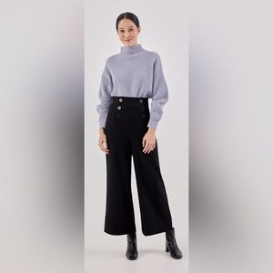 Buttoned black Love Bonito pants.